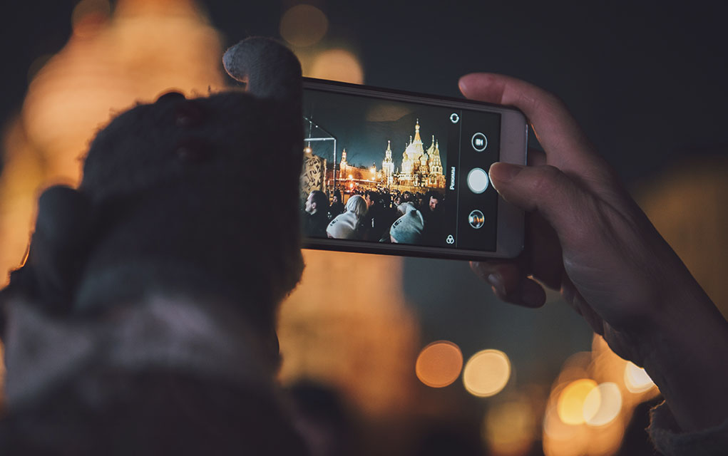 A smartphone user composes a photograph.