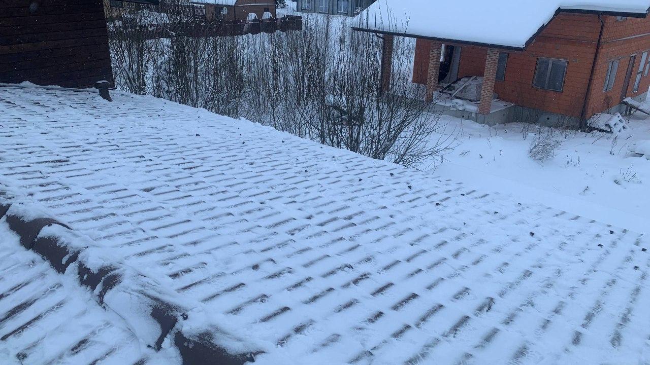 Очистка кровли дома от снежного покрова.