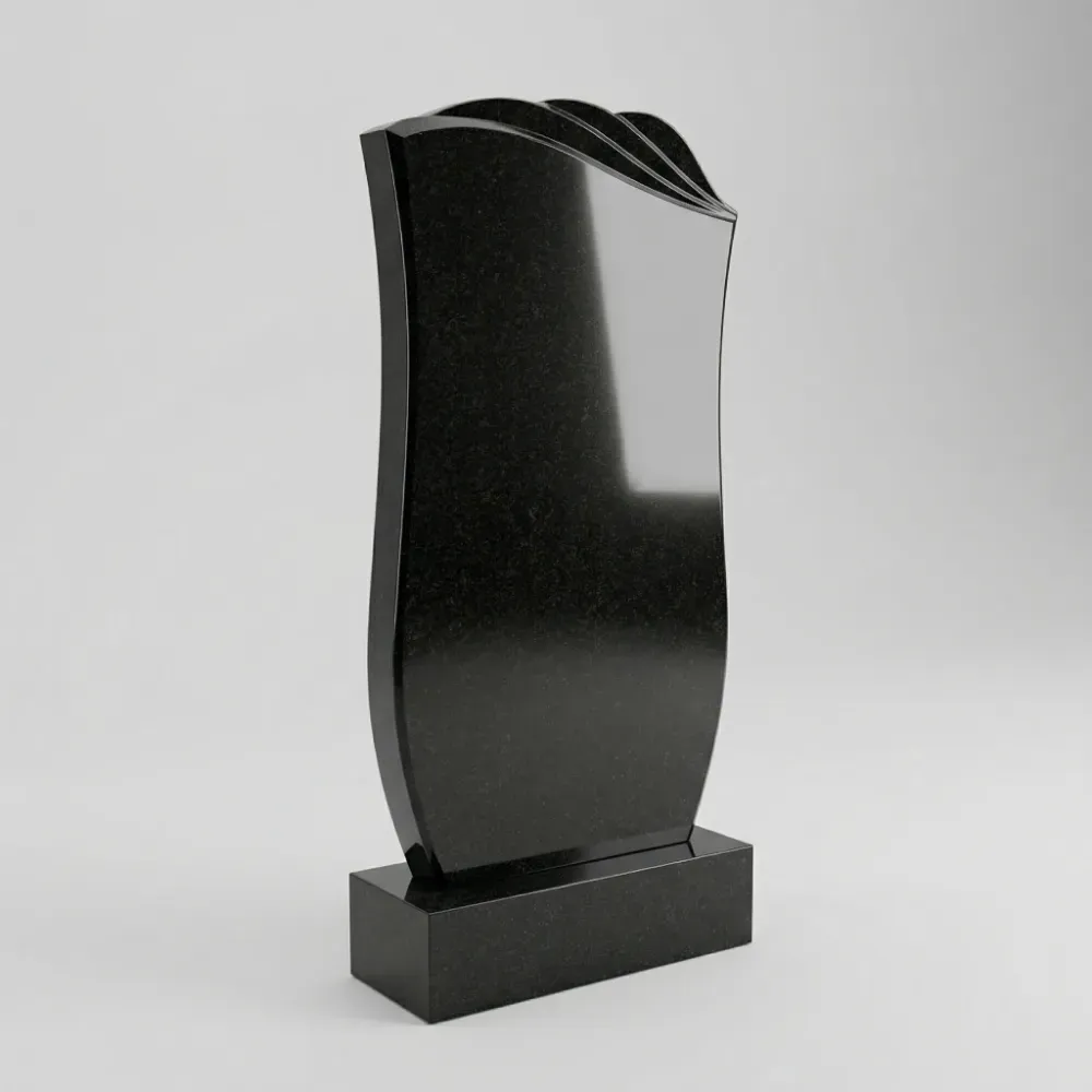 Резной гранитный памятник с элементами перьев